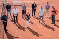Landrat Hans-Jürgen-Patrauschke und Projektleiter Josef Zander stehen mit 7 weiteren Menschen, unter EInhaltung von Hygieneabständen, auf einem Tennisplatz. Einige halten Tennisschläger.